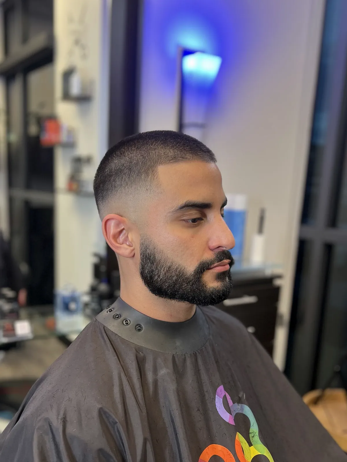 Short crop with a skin fade and shaped full beard by Cuts By Soc