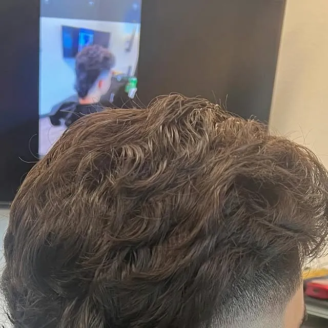 Textured mohawk-mullet haircut with a close fade by Cuts By Soc